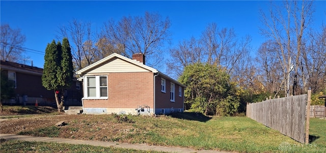 view of side of home featuring a lawn