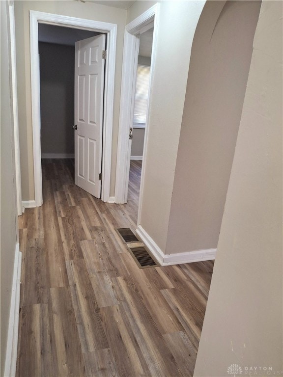 hallway with hardwood / wood-style floors