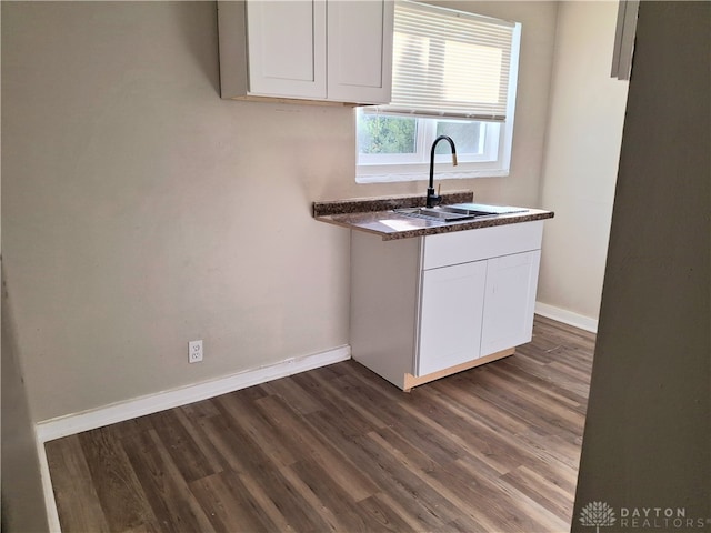 kitchen with white cabinets, dark hardwood / wood-style floors, and sink