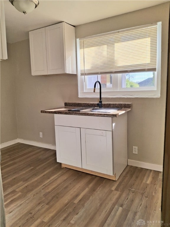 kitchen featuring white cabinets, dark hardwood / wood-style floors, and a healthy amount of sunlight