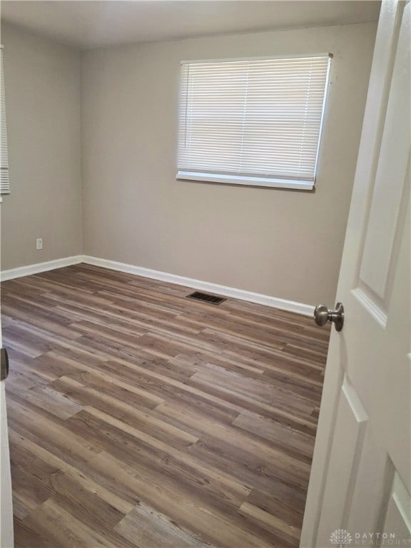 spare room featuring dark hardwood / wood-style floors