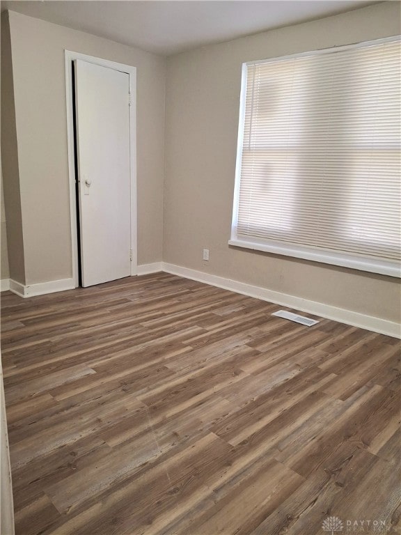 spare room featuring dark wood-type flooring