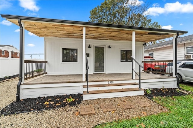 exterior space featuring fence and a porch