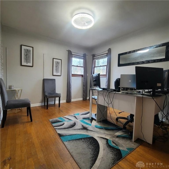 office space featuring wood-type flooring and baseboards