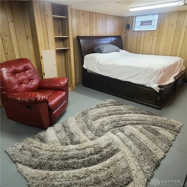 bedroom featuring wood walls