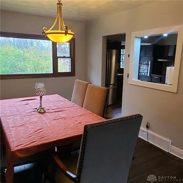 dining space with dark wood-type flooring