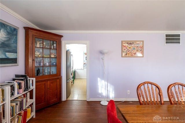 dining area featuring crown molding and dark wood-type flooring