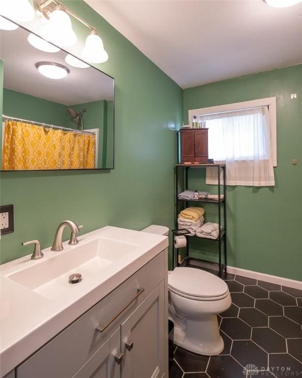 bathroom with tile patterned floors, vanity, toilet, and a shower with shower curtain