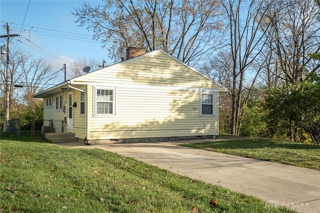 view of property exterior featuring central AC and a lawn