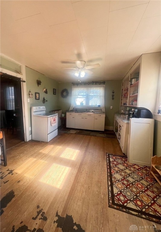 kitchen with white electric range oven, ceiling fan, white cabinets, and light wood-type flooring