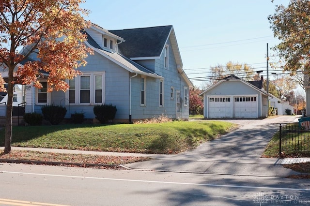 view of property exterior with a garage, a yard, and an outdoor structure