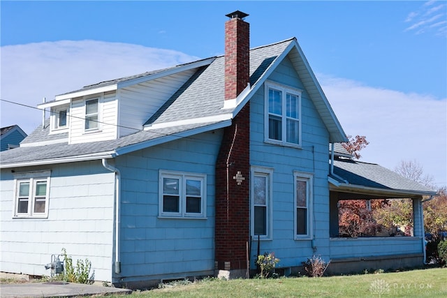 rear view of property with a yard