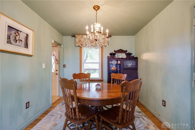 dining room featuring a notable chandelier and light hardwood / wood-style flooring