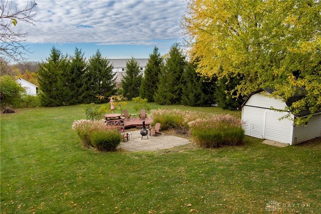 view of yard with a patio area and a storage shed