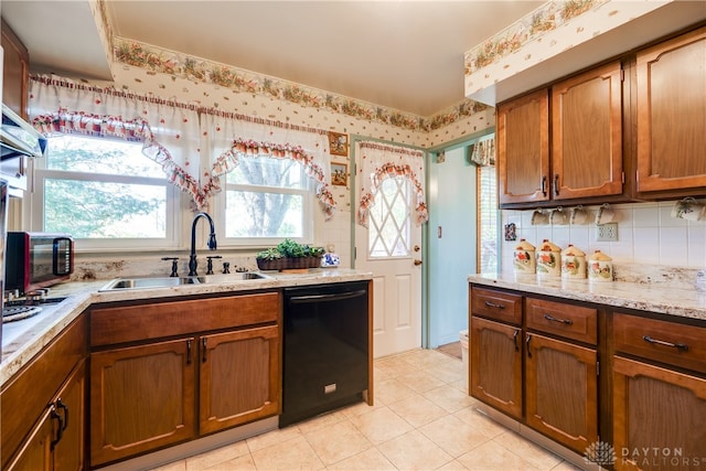 kitchen with decorative backsplash, light stone countertops, sink, light tile patterned floors, and dishwasher