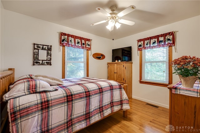 bedroom with ceiling fan and light hardwood / wood-style floors