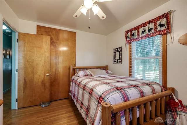 bedroom with wood-type flooring and ceiling fan