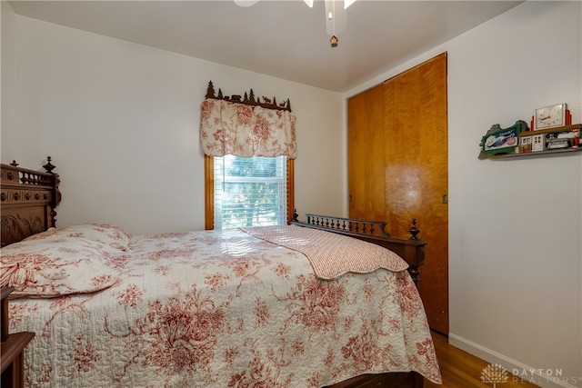 bedroom with wood-type flooring and ceiling fan