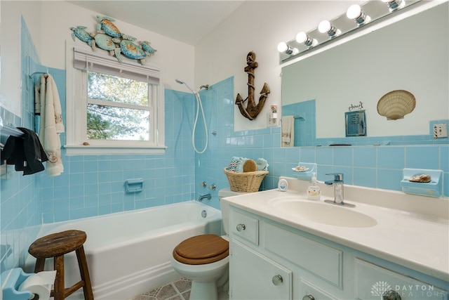 full bathroom featuring vanity, toilet, tile walls, and tiled shower / bath combo