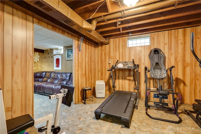 exercise room with wood walls