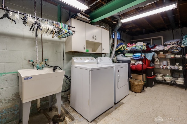 laundry area featuring cabinets, sink, and washing machine and clothes dryer