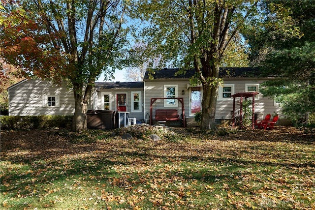 view of front of home featuring a front yard and a hot tub