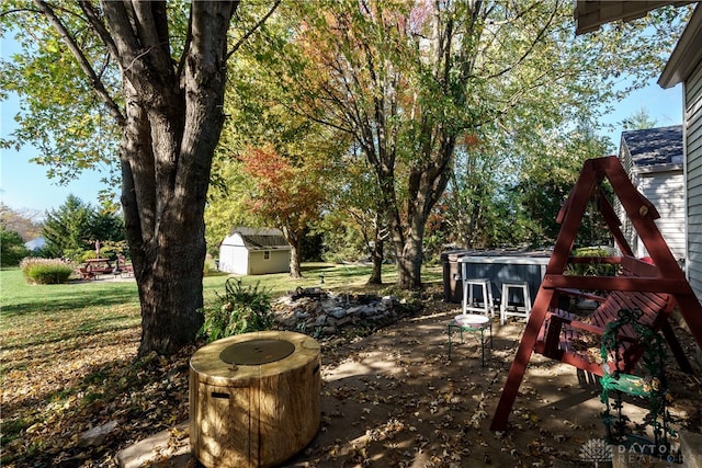 view of yard with a playground and a storage unit