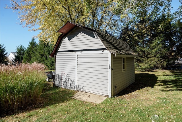 view of outdoor structure featuring a lawn