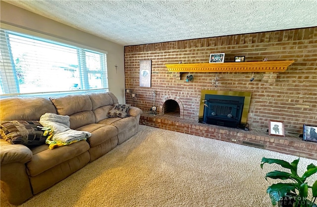 living room with brick wall, a textured ceiling, carpet floors, and a brick fireplace