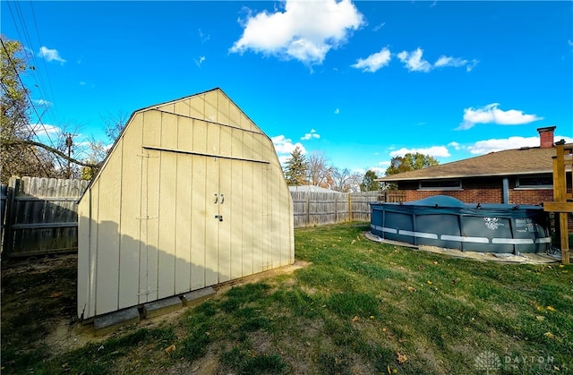 view of outdoor structure with a covered pool and a yard