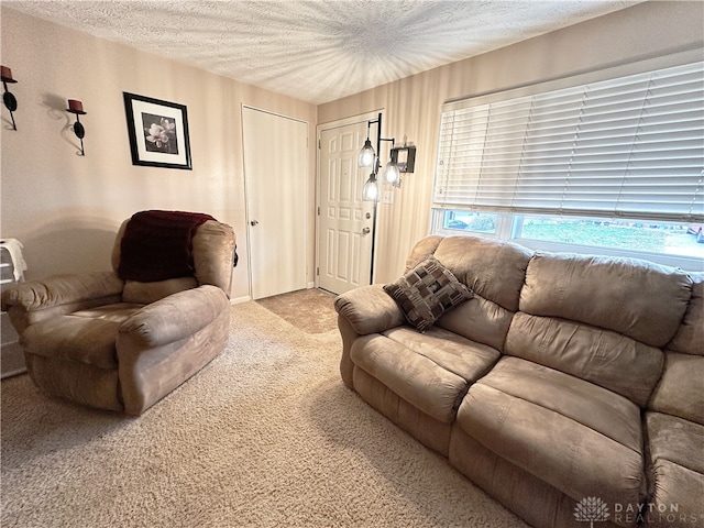 living room featuring light carpet and a textured ceiling