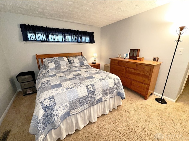 bedroom featuring multiple windows, a textured ceiling, and light carpet