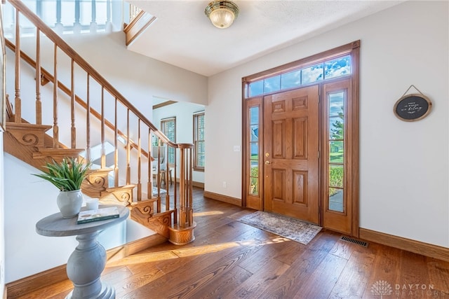 entrance foyer with dark hardwood / wood-style flooring