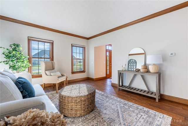 living room with dark hardwood / wood-style floors and crown molding