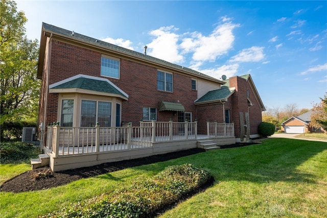 rear view of house featuring central AC unit, a garage, a deck, an outdoor structure, and a lawn