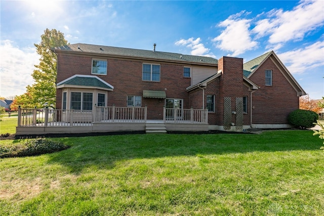 back of house featuring a yard and a deck