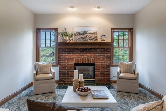 living room with a brick fireplace and a textured ceiling