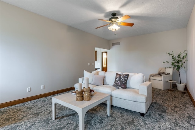 carpeted living room with ceiling fan and a textured ceiling