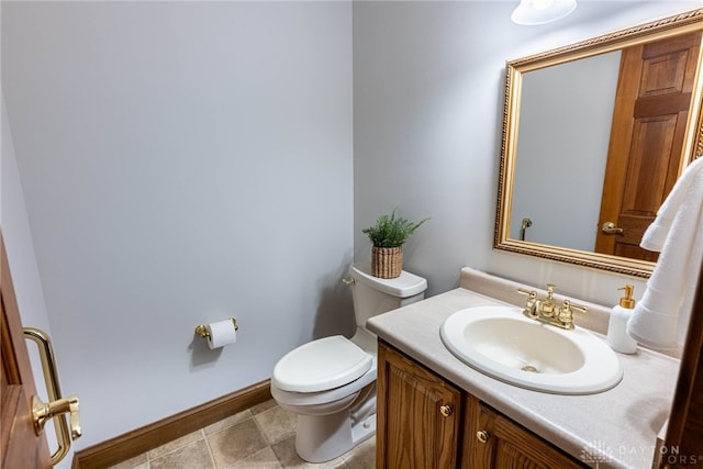 bathroom with tile patterned flooring, vanity, and toilet