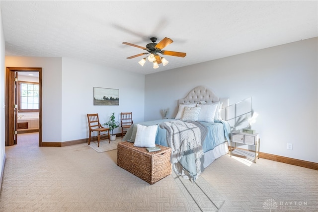 bedroom featuring a textured ceiling, light colored carpet, and ceiling fan