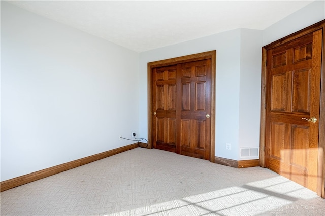 unfurnished bedroom with light colored carpet