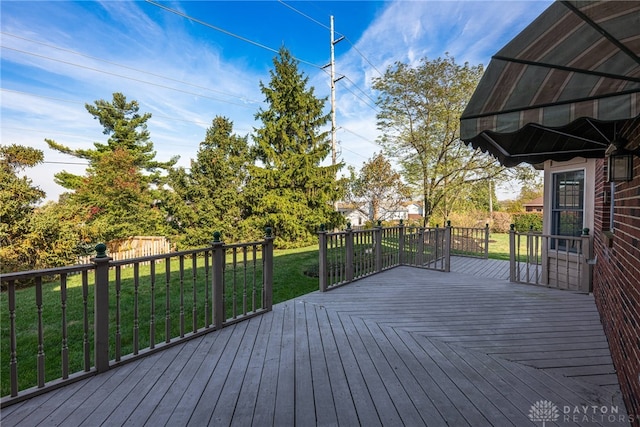 wooden deck featuring a yard