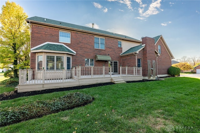 back of house with a yard and a deck