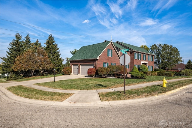 view of front of house featuring a garage and a front lawn