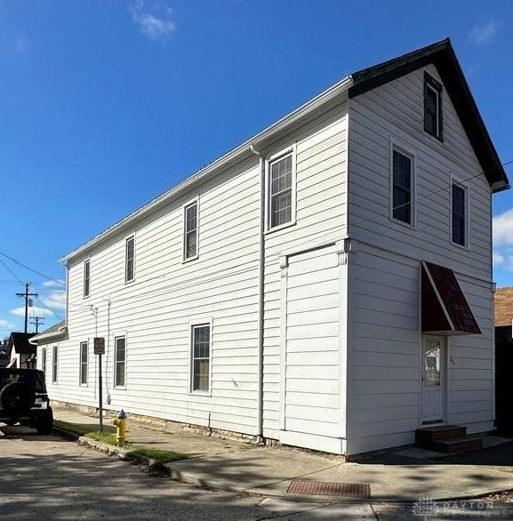 view of side of home with entry steps