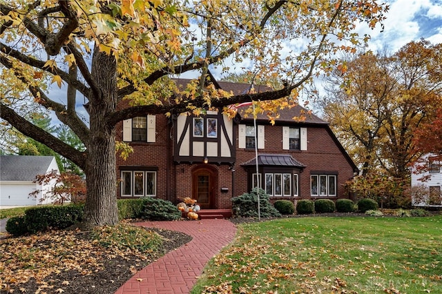 english style home with a front yard