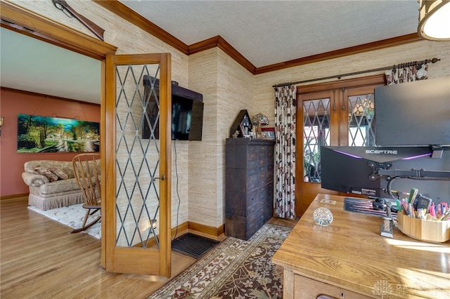 office area featuring ornamental molding, french doors, wood-type flooring, and a textured ceiling