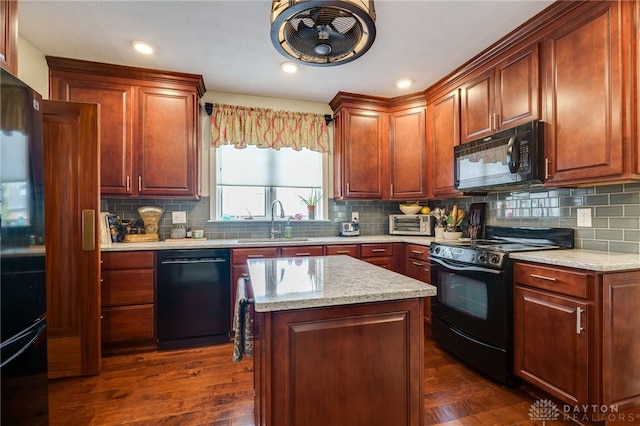 kitchen featuring black appliances, dark hardwood / wood-style floors, sink, and backsplash