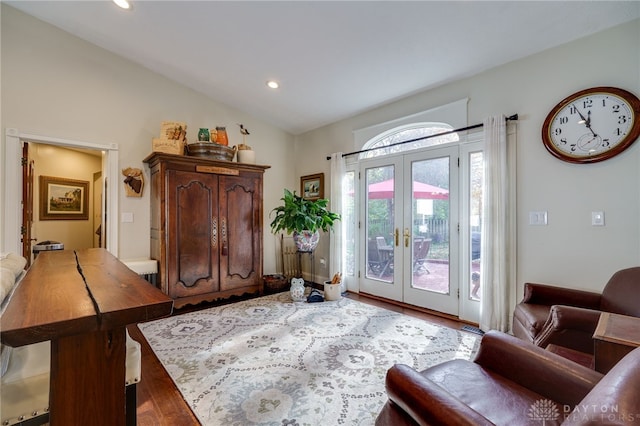 entryway with french doors, lofted ceiling, and hardwood / wood-style flooring