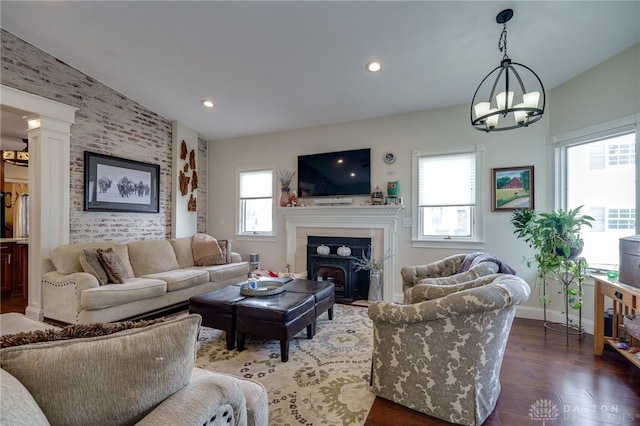 living room with dark hardwood / wood-style flooring and an inviting chandelier